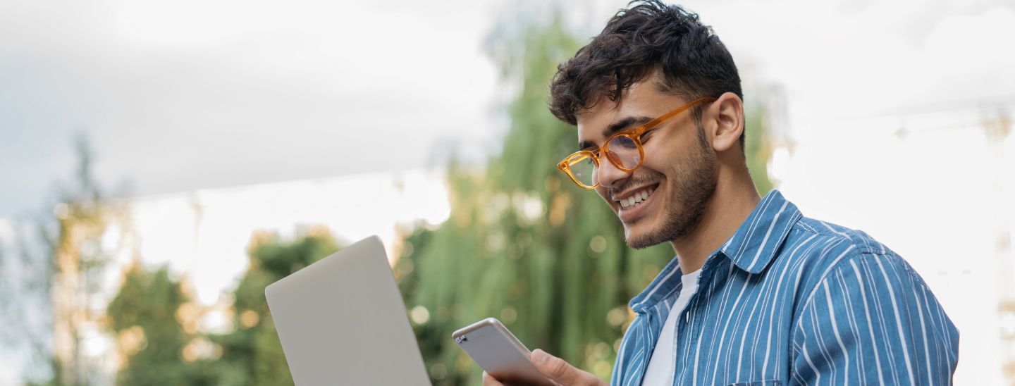 Male looking at phone smiling