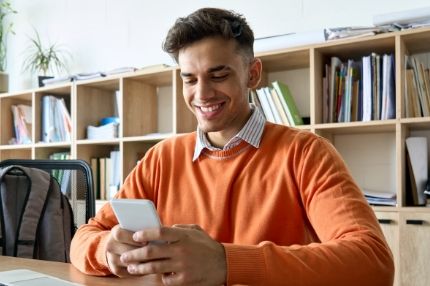 Man looking at phone smiling